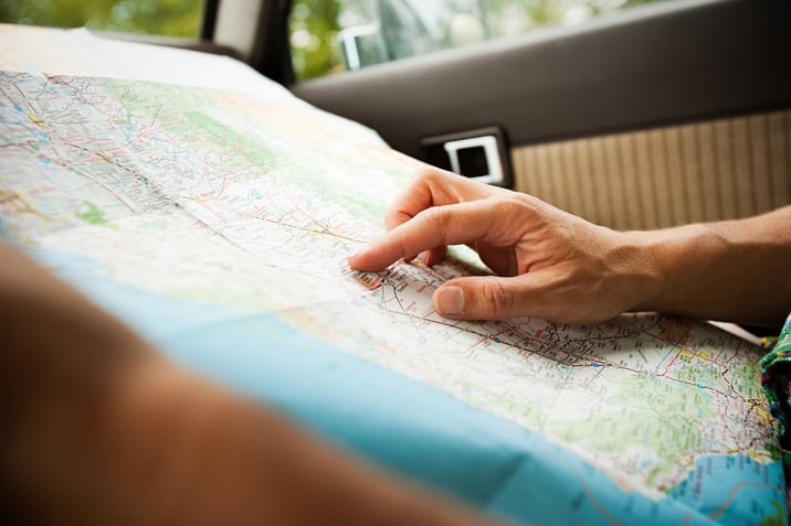 A passenger using a map for route planning a trip