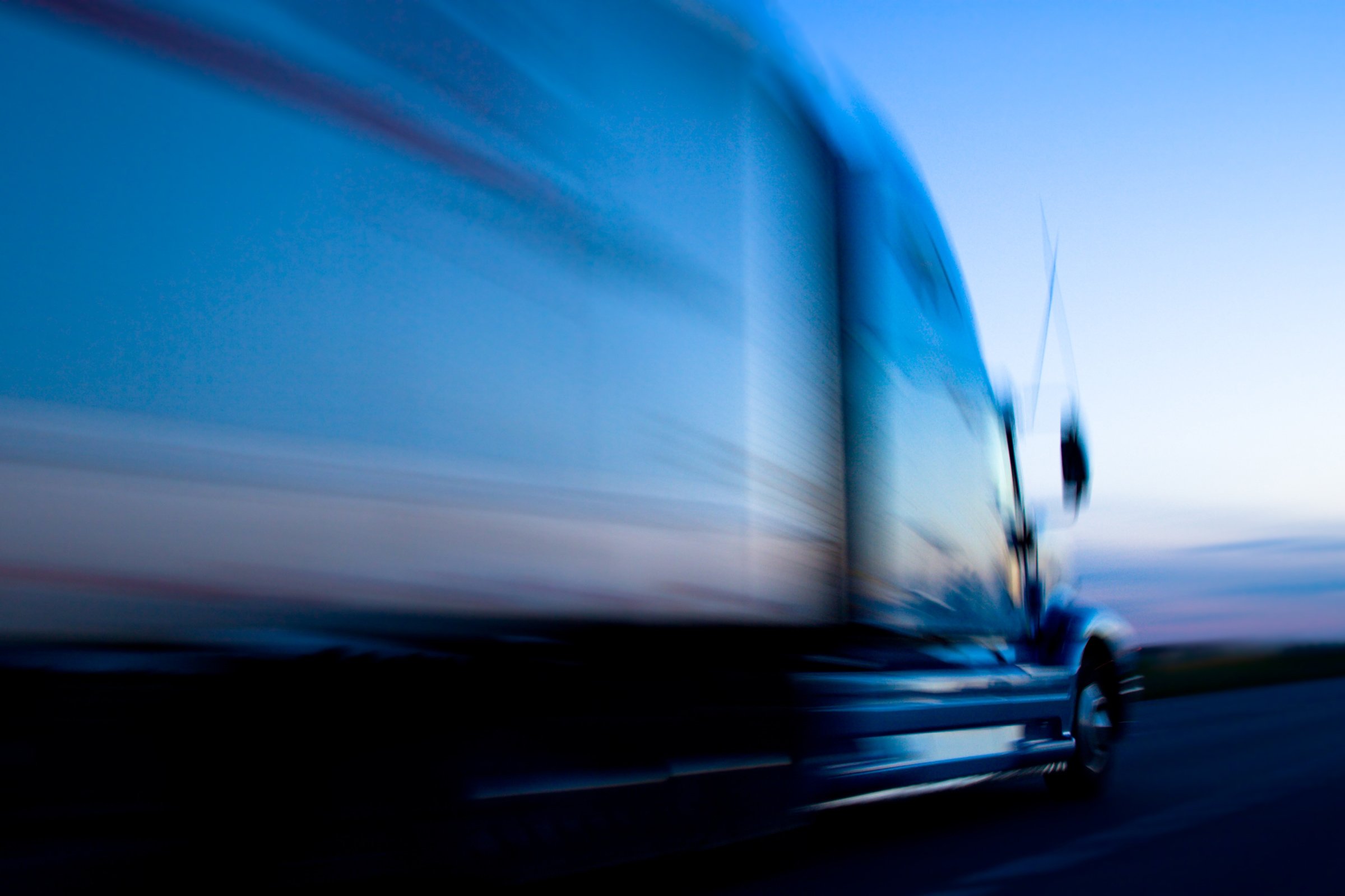 Truck Speeding Down The Freeway At Dusk 