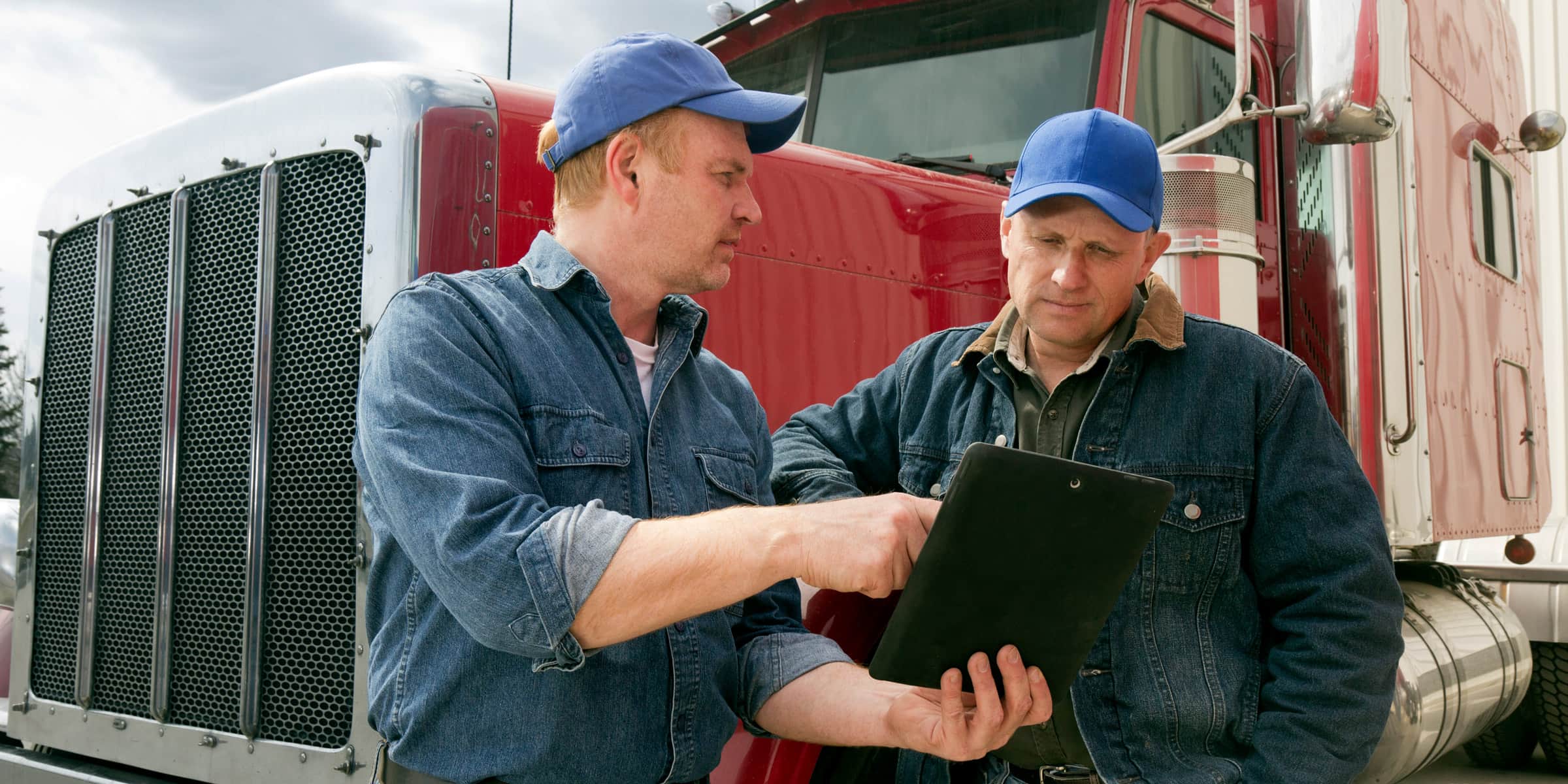 Truck drivers talking with iPad 
