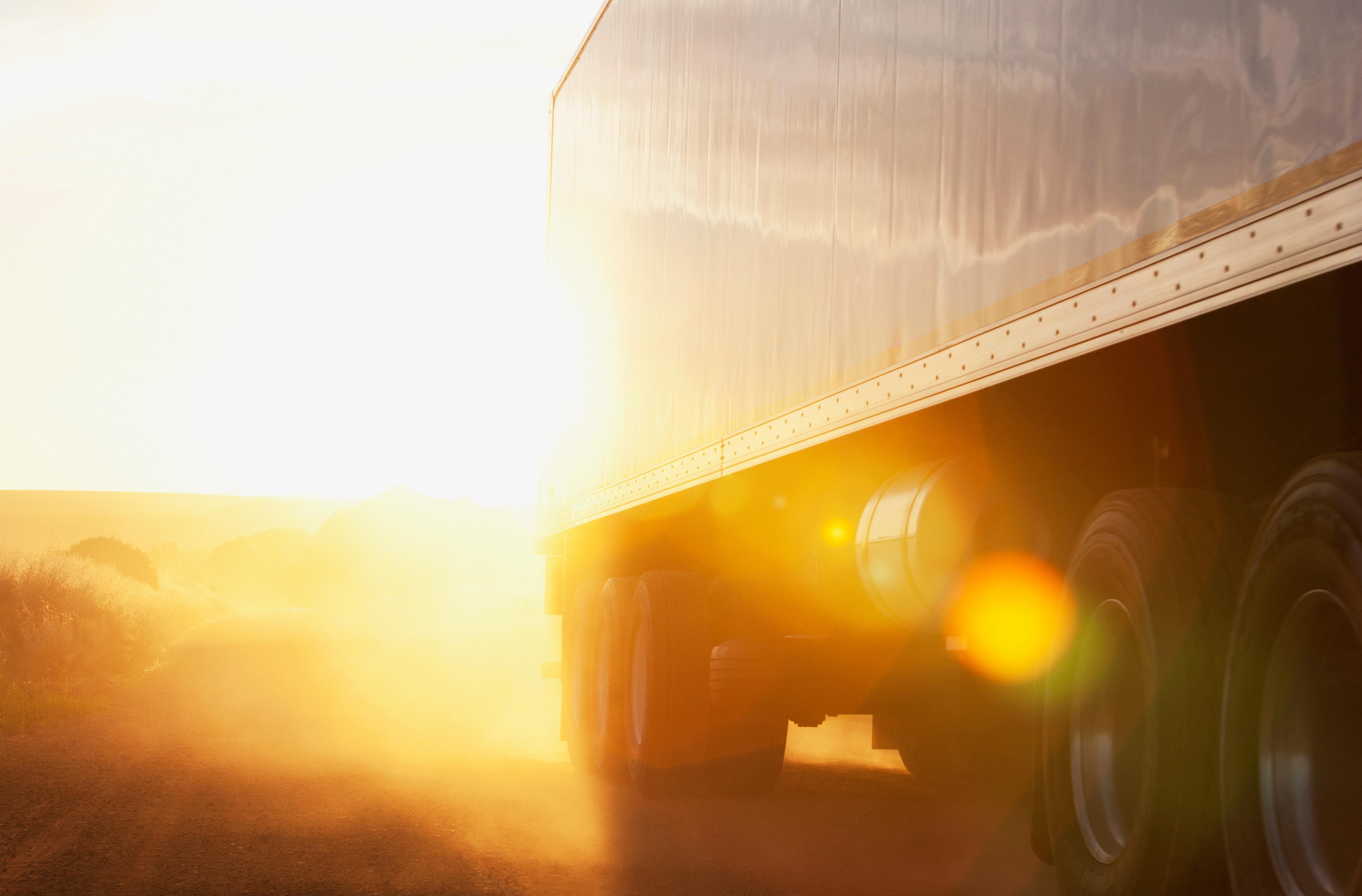 Truck driving at sunset