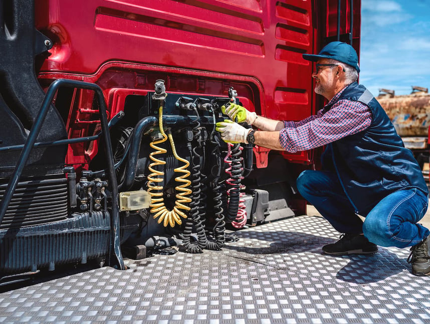 Trucker fixes the cables on his truck