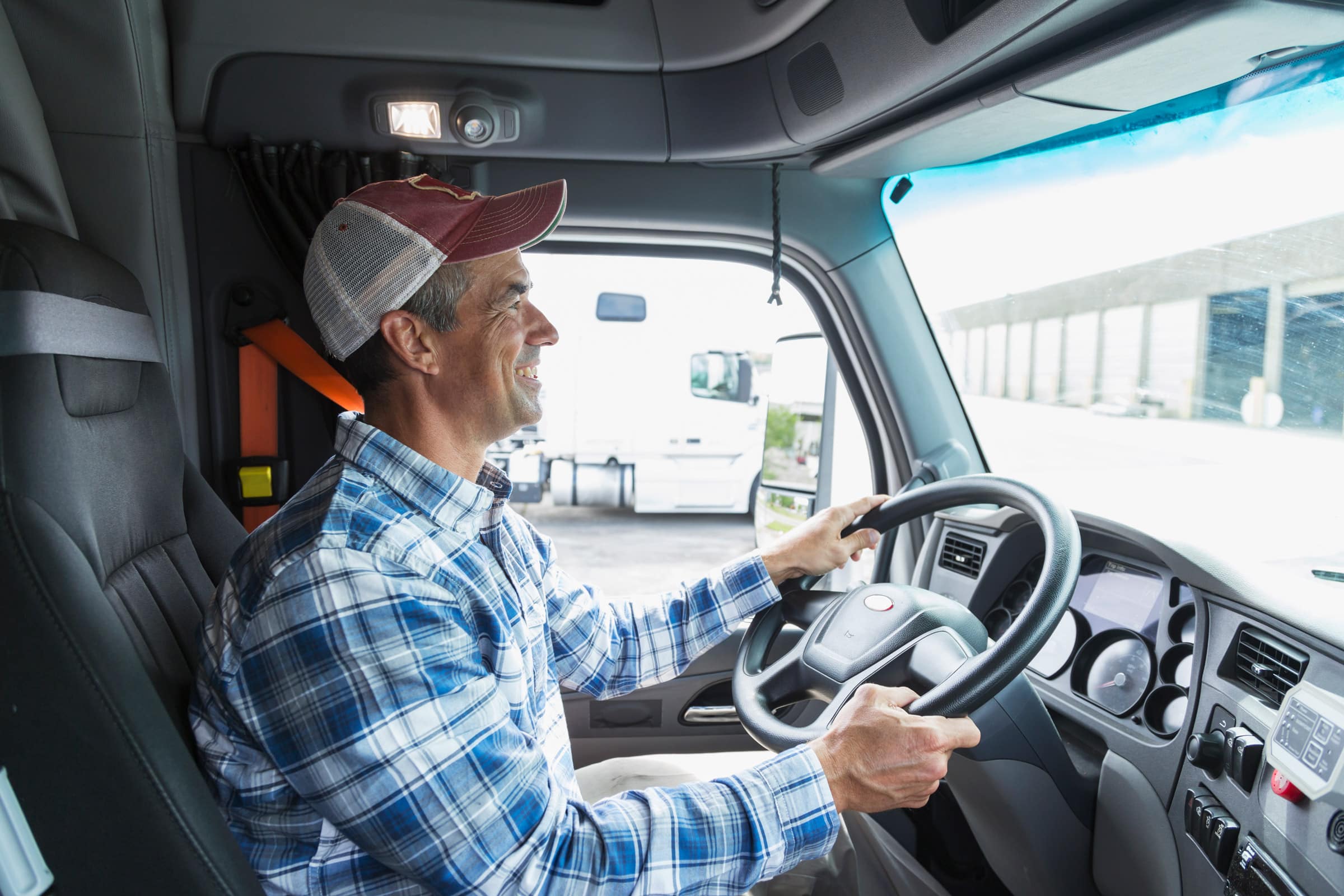 Smiling-Truck-Driver-In-Truck-Cab