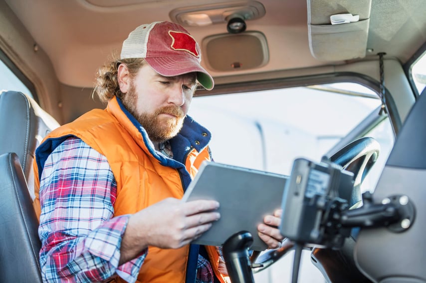 Trucker uses his tablet to complete an employee assistance program