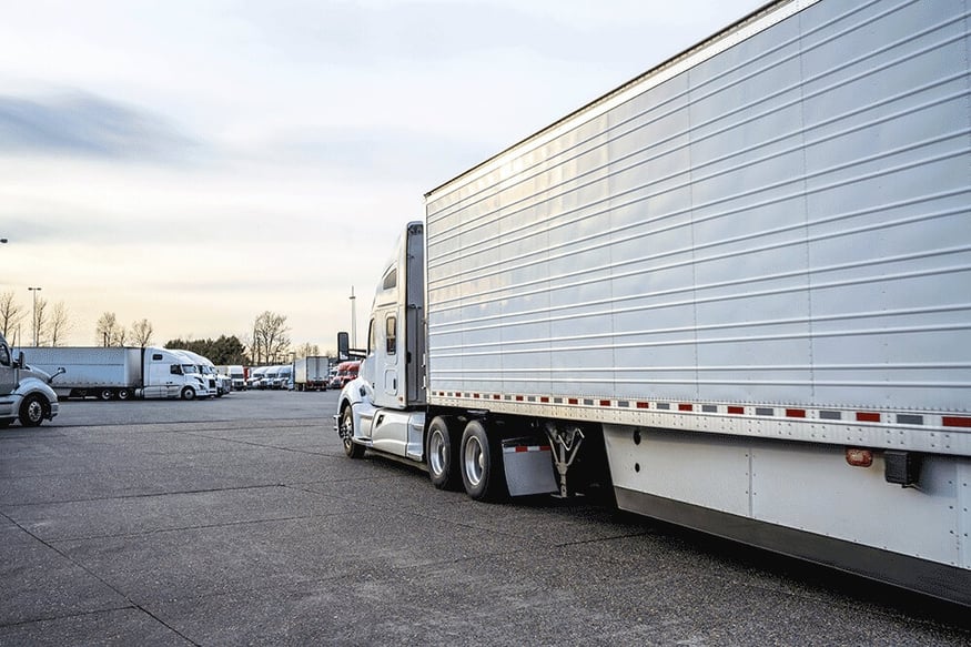 Semi truck passing by parking stalls