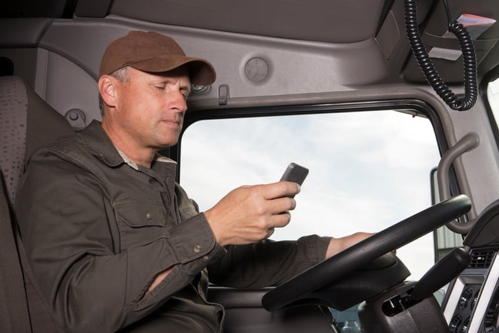 a truck driver texting while driving