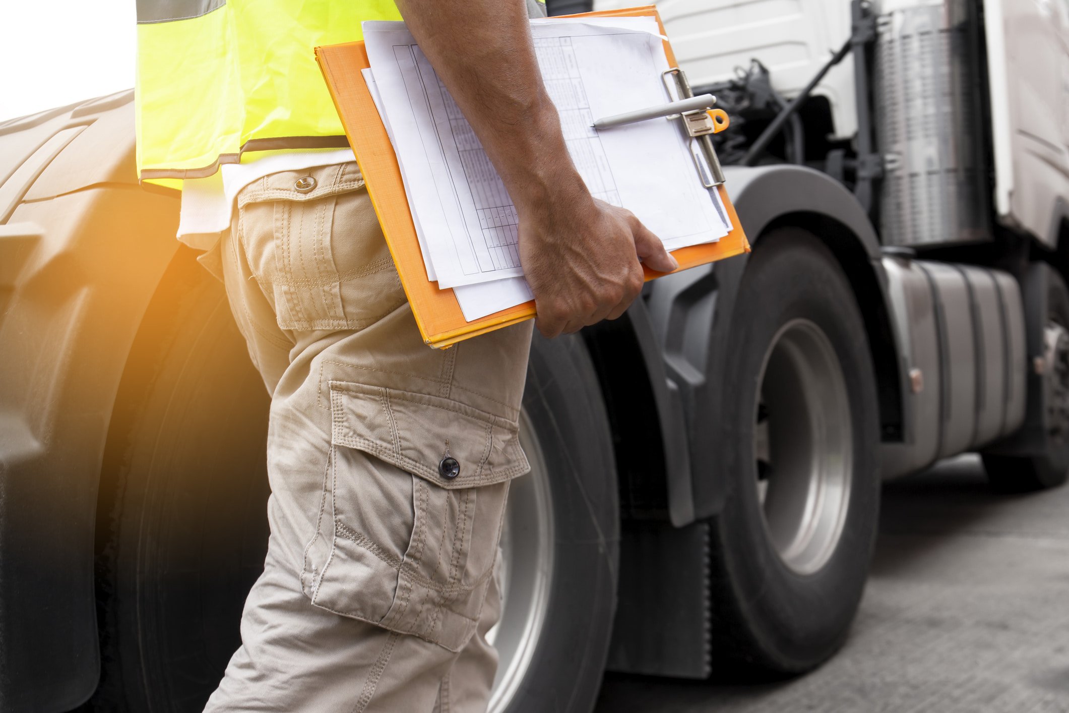 a man carrying a clipboard conducting a brake inspection