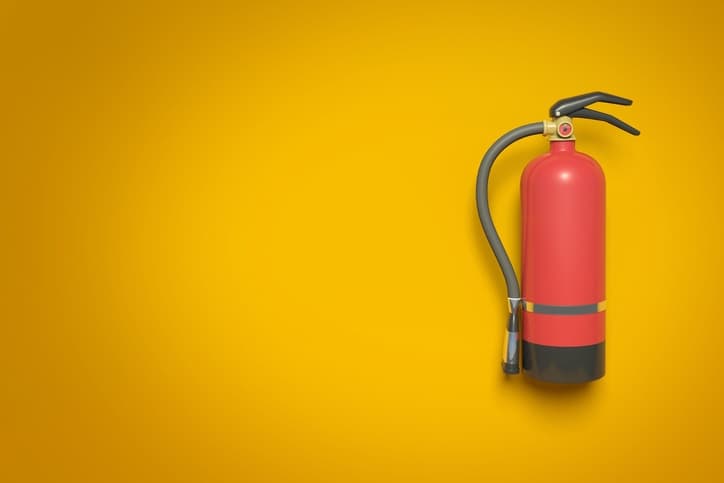 a fire extinguisher hanging on a wall