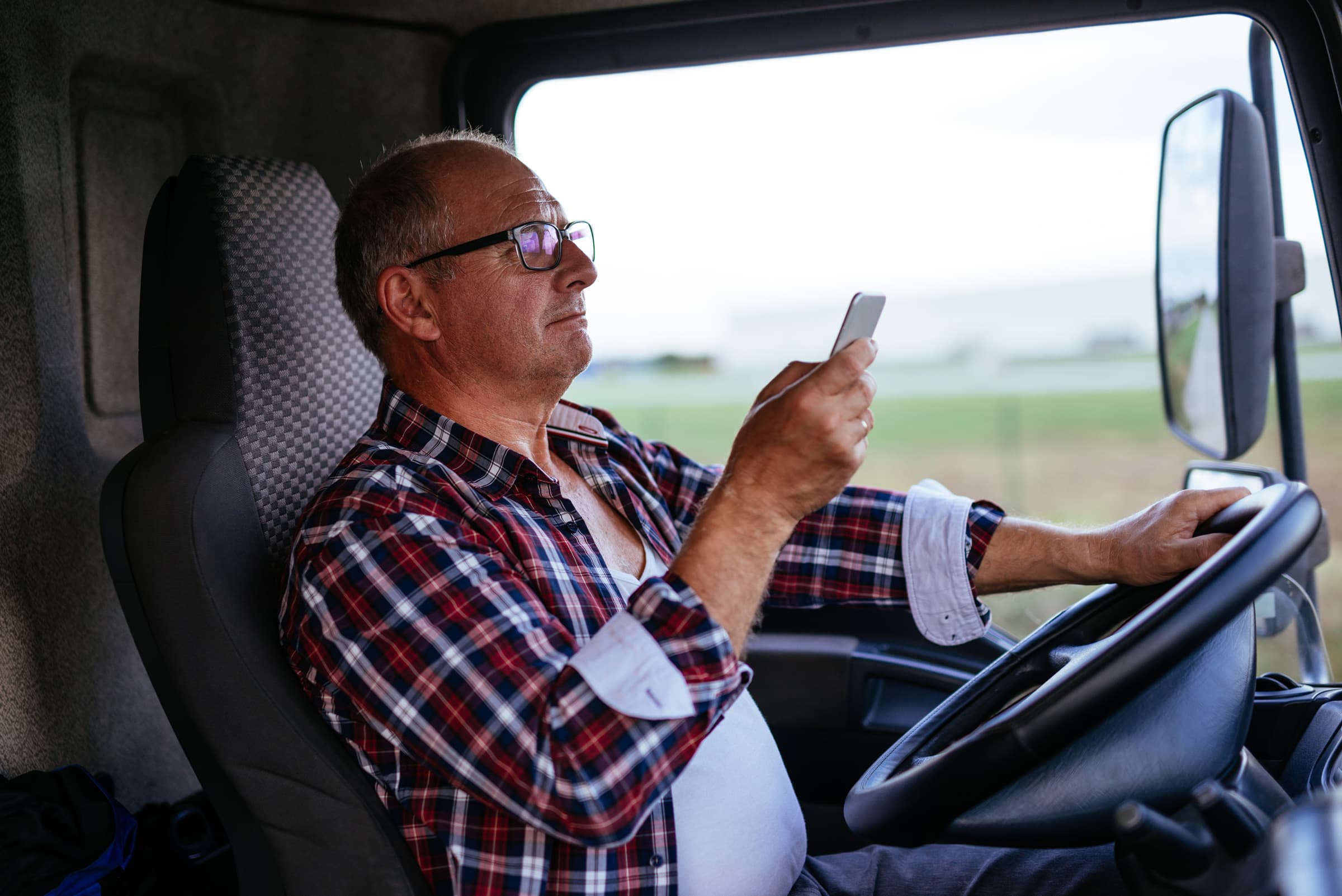 Truck-Driver-Looking-At-Phone-While-Driving