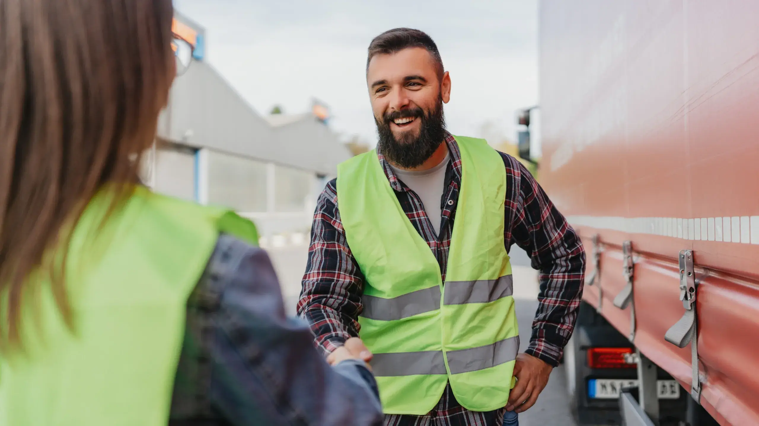 Truck drivers shake hands after post-accident coaching